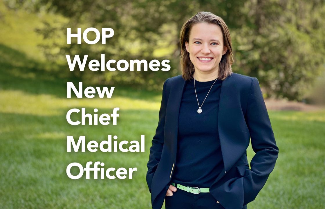Dr. Alina Fomovska stands on the grass alongside the words "HOP Welcomes New Chief Medical Officer"