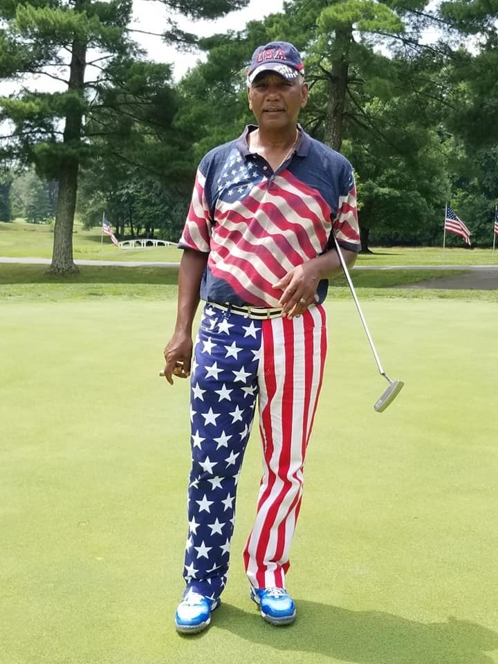 A male golfer in american flag clothing