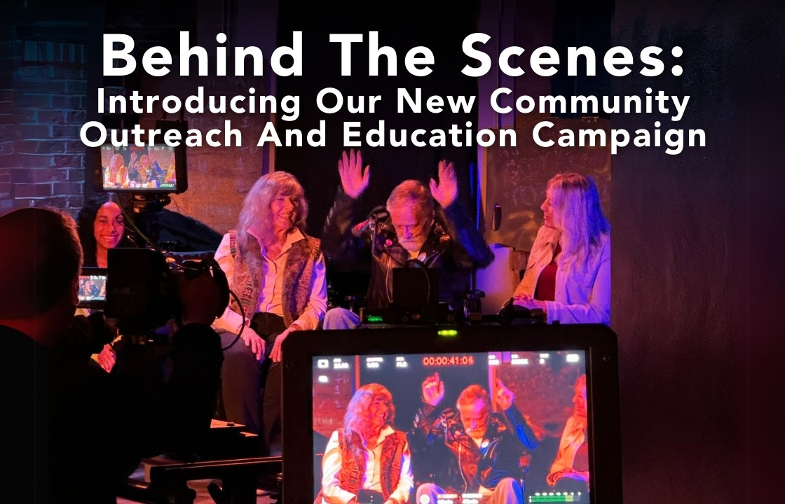 The filming of a family watching a concert. An older man in a leather jacket raises his hands in the air. He sits between his wife and daughter. "Behind The Scenes: Introducing Our New Community Outreach And Education Campaign"