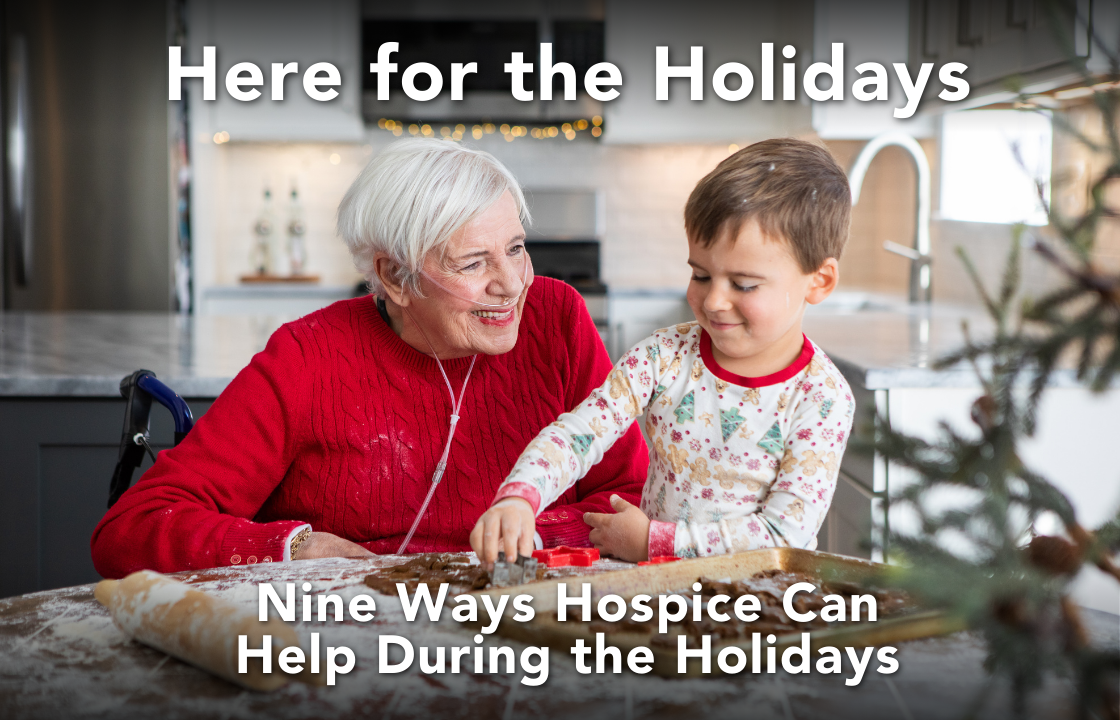 a hospice patient in a red sweater with a oxygen canula makes gingerbread cookies with her grandson who wears Christmas pajamas. Text on the image reads: Here for the Holidays. Nine Ways Hospice Can Help During the Holidays