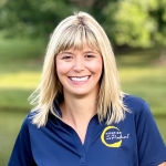 Hannah Barton wears a blue polo shirt with a yellow Hospice of the Piedmont logo