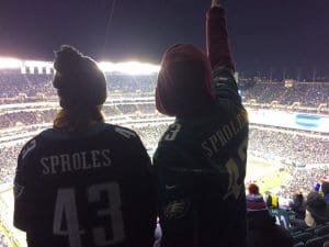 Two Philadelphia Eagles fans at a night game wearing 'Sproles' jerseys