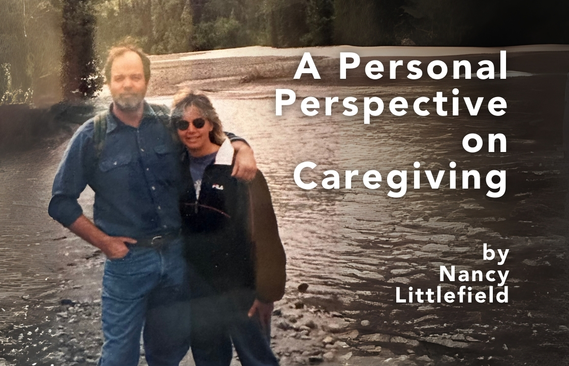 Hospice of the Piedmont President and CEO Nancy Littlefield wears a fleece jacket and jeans. She stands next tor her brother Dave, bearded wearing a denim shirt and jeans. They stand at the bend of a slow moving river with trees in the distance.