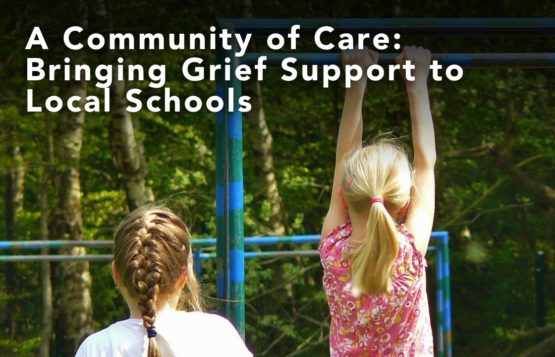 Two young girls play on outdoor monkey bars in a wooded area, with one hanging and the other watching. Overlaid text reads, “A Community of Care: Bringing Grief Support to Local Schools.”
